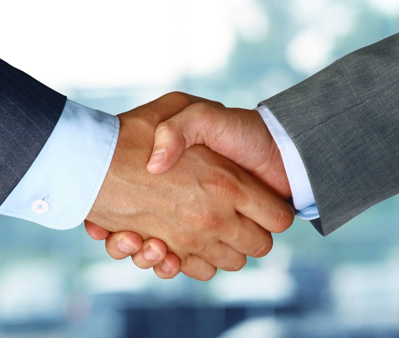 Two people shaking hands after a friendly conversation