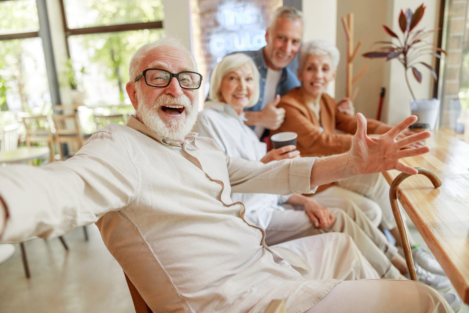 A group of older adults laughing together in a community space